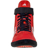 Red Adidas wrestling shoe with black strap and sole on a white background