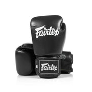 Black boxing gloves with Fairtex logo on a white background