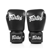Pair of black Fairtex boxing gloves on a white background