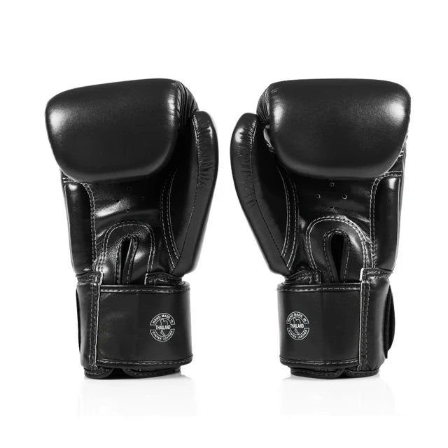 Pair of black boxing gloves on a white background