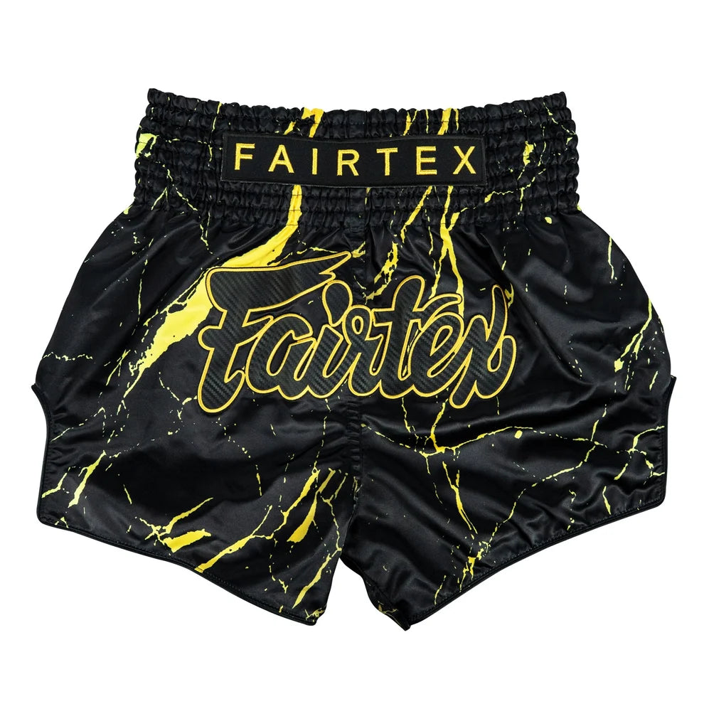 Black and yellow Fairtex shorts on a white background