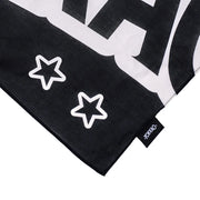 Black and white patterned fabric with star designs and a visible brand tag.