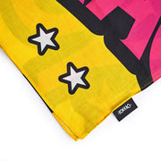 Colorful fabric with star patterns and a visible brand label on a white background