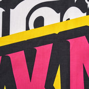 Close-up of colorful text with pink, yellow, and white letters on a black background