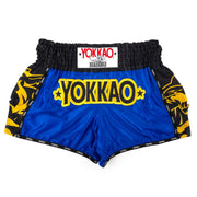 Blue Yokkao boxing shorts with black and yellow accents on a white background
