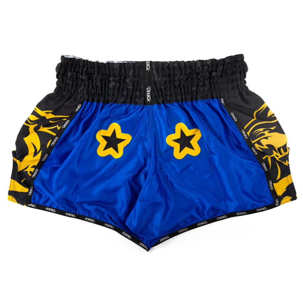 Blue athletic shorts with yellow star designs and black accents on a white background