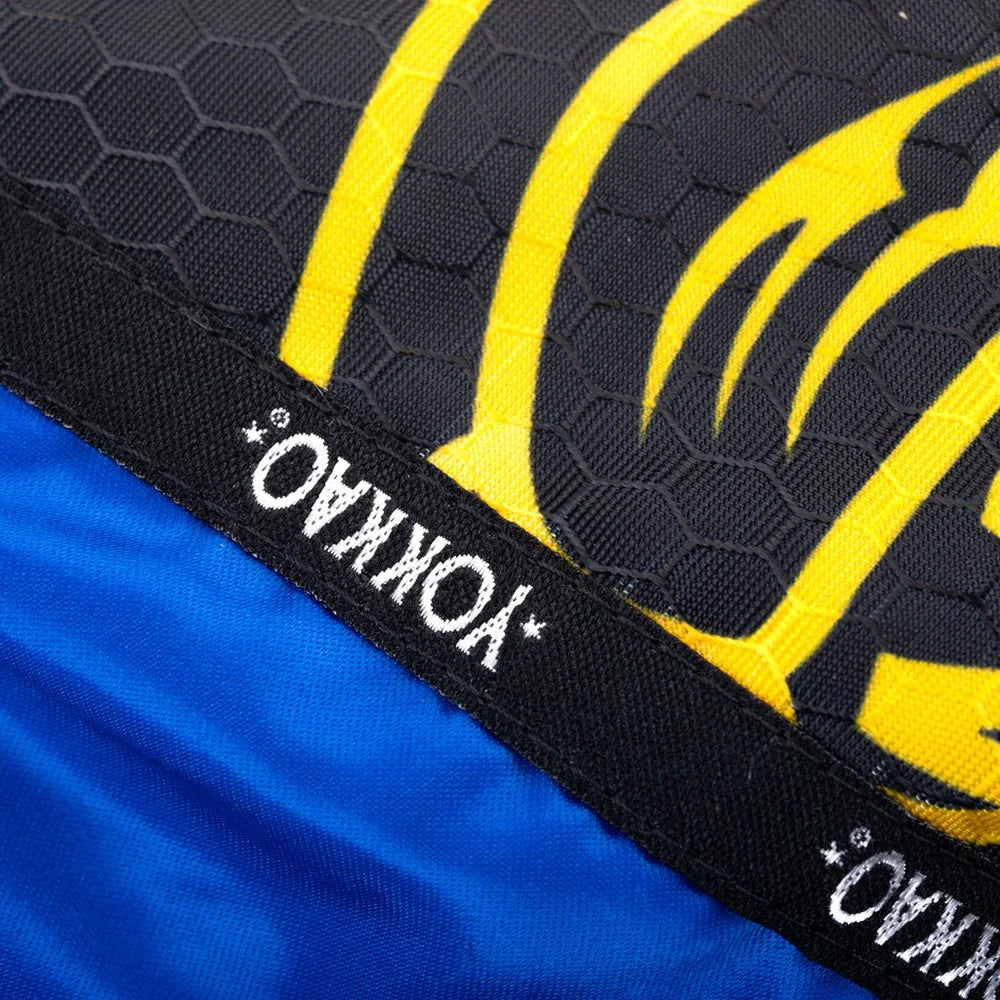Close-up of a sports product with yellow tiger design and Yokkao branding.