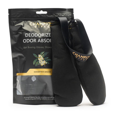 Black boxing gloves with Champion Wipes packaging on a white background