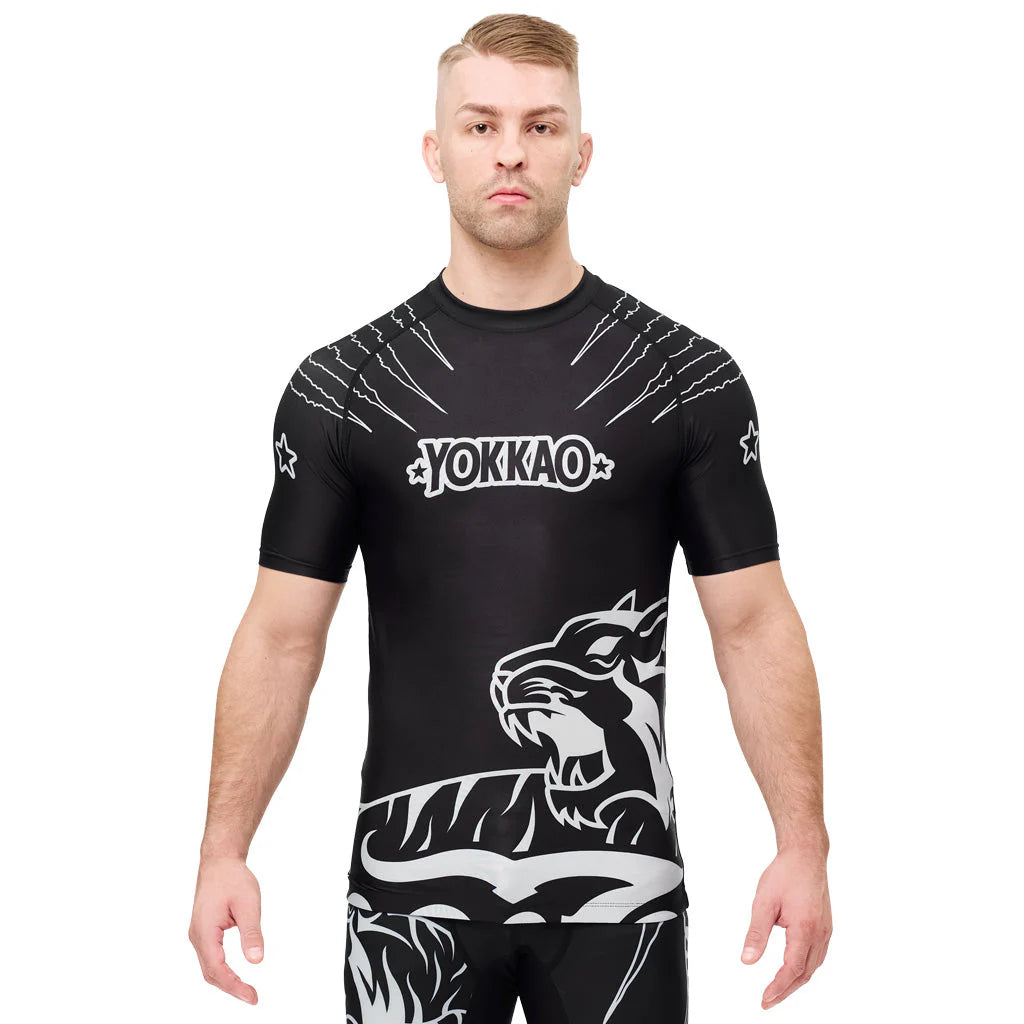 Man wearing a black athletic shirt with white graphics and 'Yokkao' branding on a white background