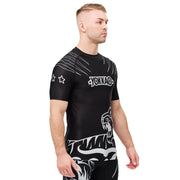 Man wearing a black athletic shirt with white designs and 'Yonaka' branding on a white background