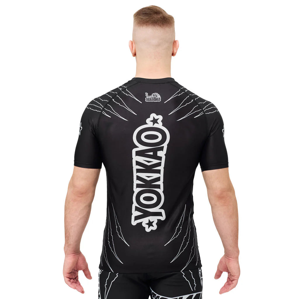 Person wearing a black sports outfit with 'YOKKAO' branding on the back.
