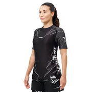 Woman wearing a black athletic outfit with branding on a white background