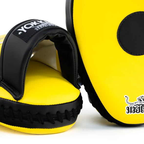 Yellow and black boxing focus mitts with visible branding on a white background