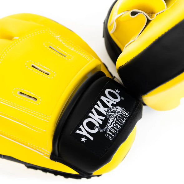 Yellow and black boxing gloves with 'Yokkao' branding on a white background
