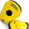 Yellow boxing mitts with black center and 'Yokkao' branding on a white background