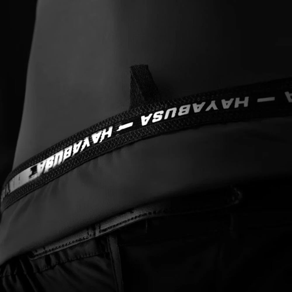 Close-up of a black belt with 'HAYABUSA' branding on a dark background