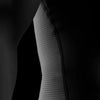 Close-up of a textured fabric sleeve against a black background