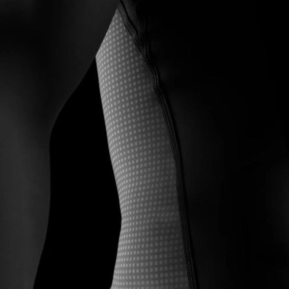 Close-up of a textured fabric sleeve against a black background