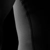 Close-up of a textured black sleeve with a pattern on a dark background