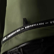 Close-up of a green jacket with a black strap featuring 'HAYABUSA' branding.