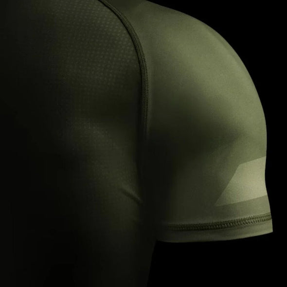Green athletic shirt with geometric pattern on a black background