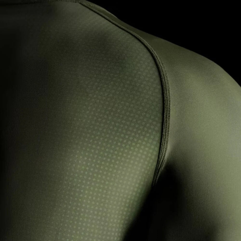 Close-up of a green athletic shirt with textured shoulder area.