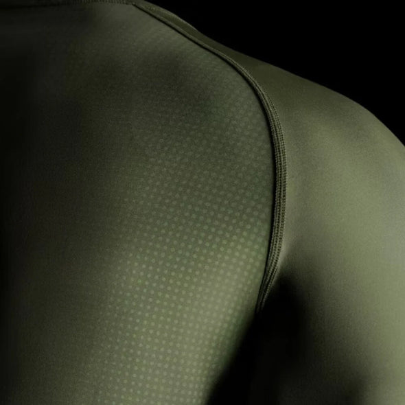 Close-up of a green athletic shirt with textured shoulder area.