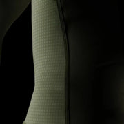 Close-up of a textured green sleeve against a black background