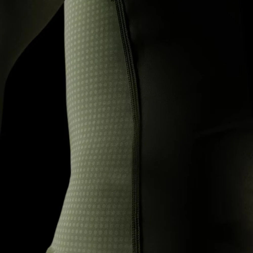 Close-up of a textured green sleeve against a black background