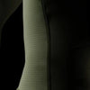 Close-up of a textured green sleeve against a black background