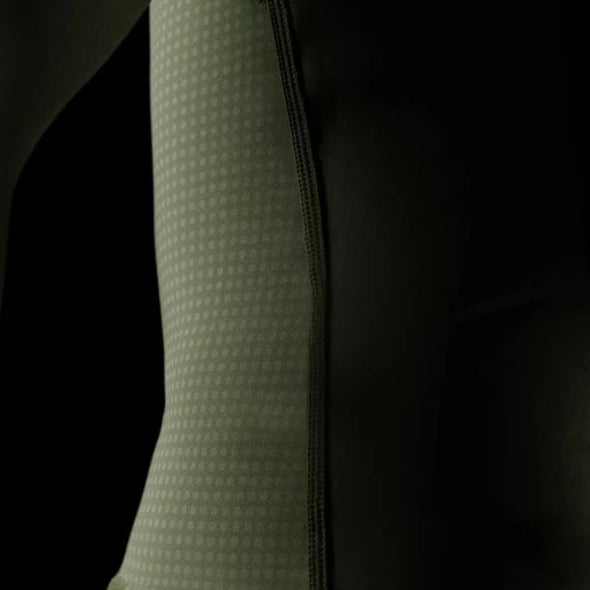 Close-up of a textured green sleeve against a black background
