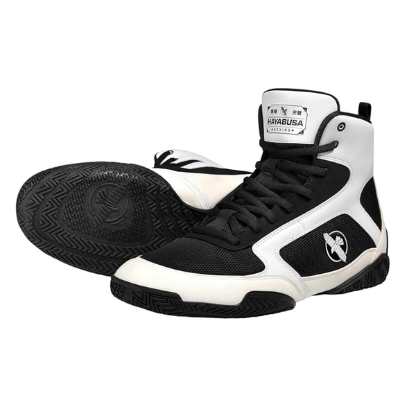 Black and white high-top shoes with visible branding on a white background