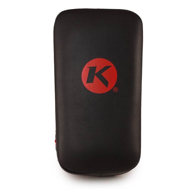 A black rectangular kickboxing or martial arts target pad with a red circular logo featuring a stylized letter 'K' in the center, shown against a plain white background.