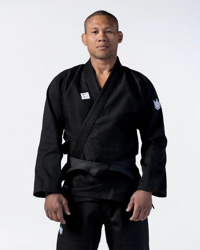 Person wearing a black martial arts uniform on a white background