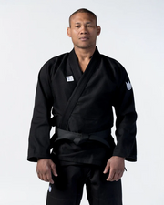 Person wearing a black martial arts uniform on a white background