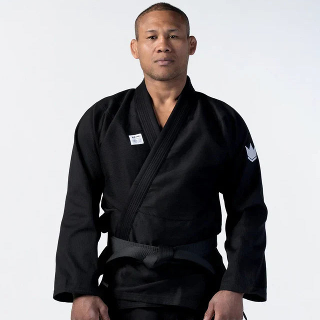 Person wearing a black martial arts uniform on a white background