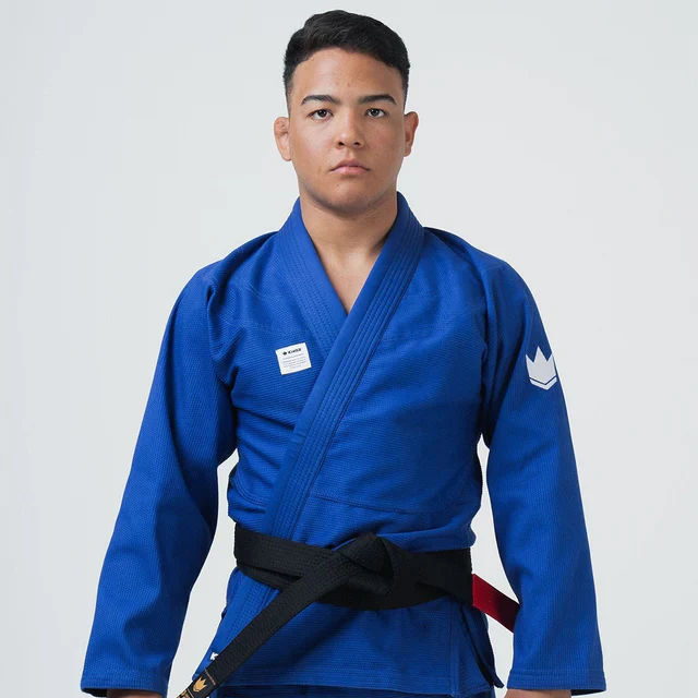Person wearing a blue martial arts uniform with a black belt on a white background