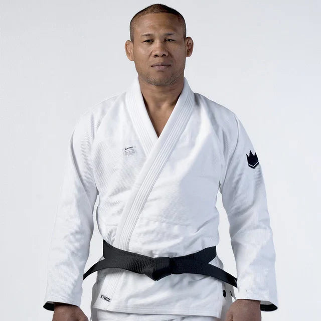 Person wearing a white martial arts uniform with a black belt on a white background
