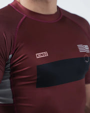 Maroon athletic shirt with 'KINGZ' logo on a plain background
