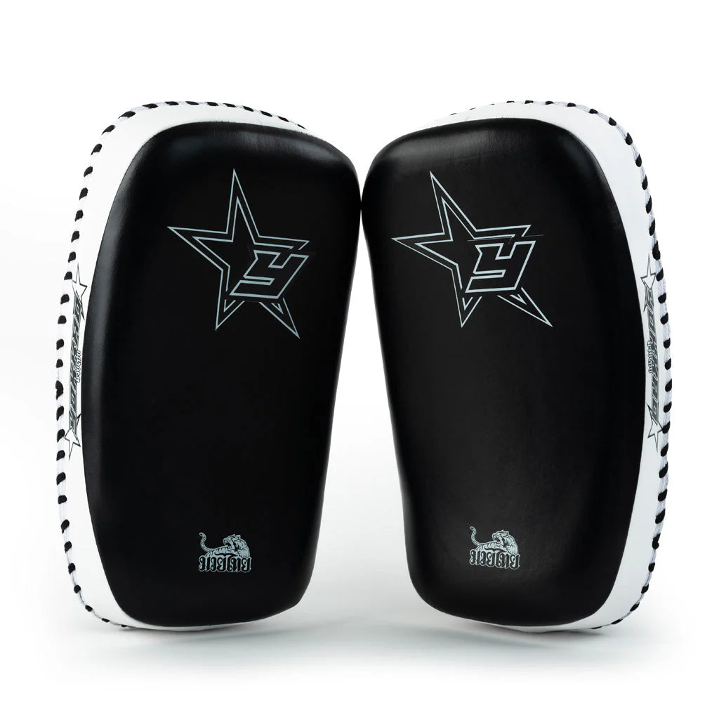 Black and white martial arts training pads with star design on a white background