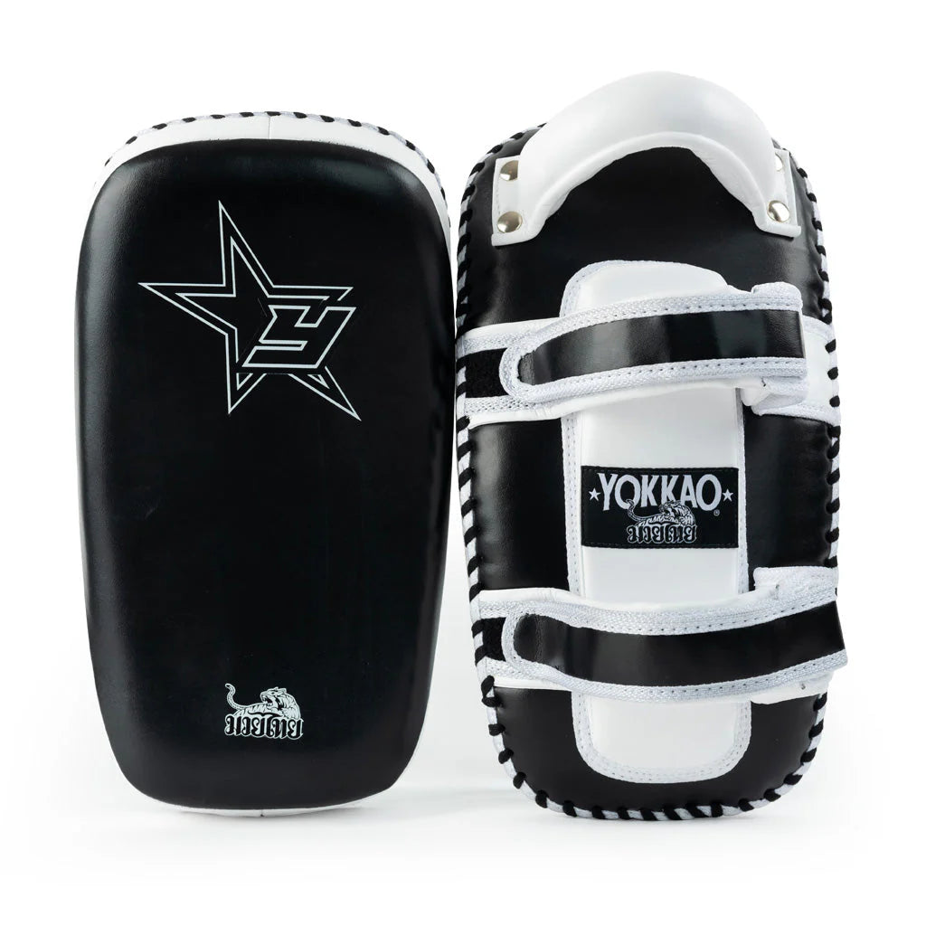 Black and white martial arts training pads with visible branding on a white background
