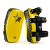 Yellow and black martial arts training pads with visible branding on a white background