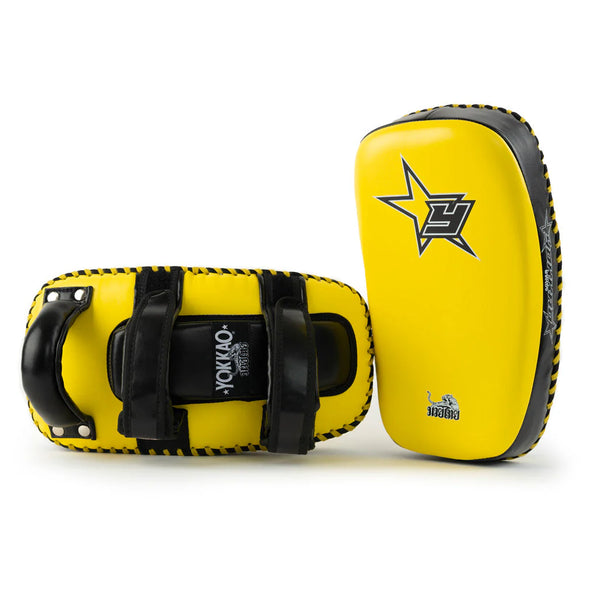 Yellow and black martial arts training pads with visible branding on a white background