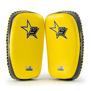 Pair of yellow and black martial arts knee pads with a star logo on a white background