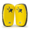 Pair of yellow and black martial arts knee pads with a star logo on a white background