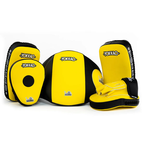 Yellow and black Yokkao martial arts gear on a white background