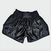 Black boxing shorts with 'Legacy' branding on a light gray background