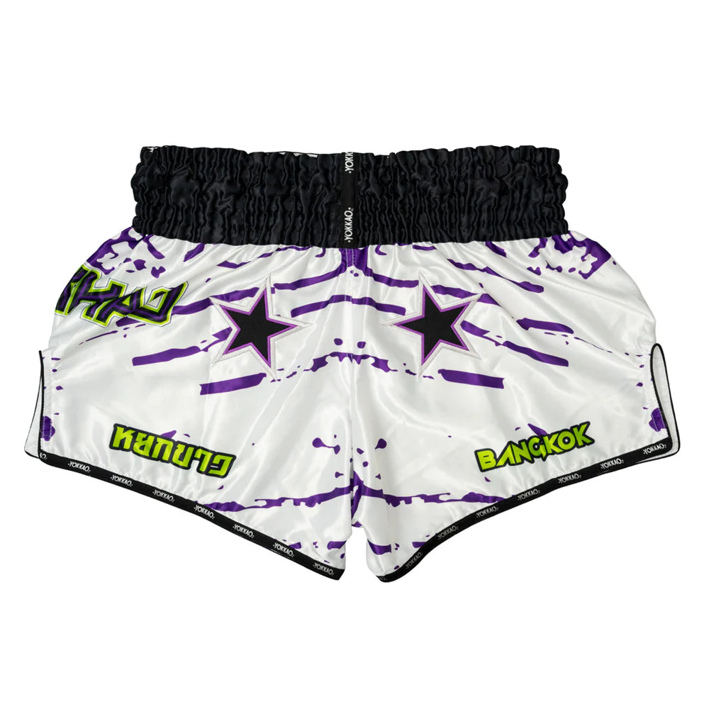 White shorts with purple star patterns and green text on a white background