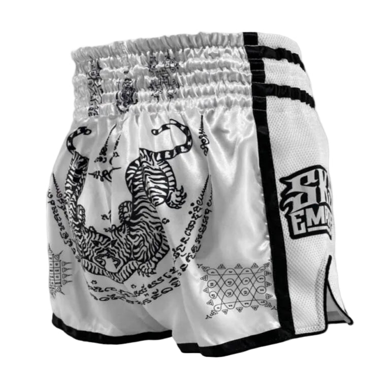 White boxing shorts with black designs and text on a light gray background