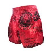 Red boxing shorts with black text and graphics on a gray background